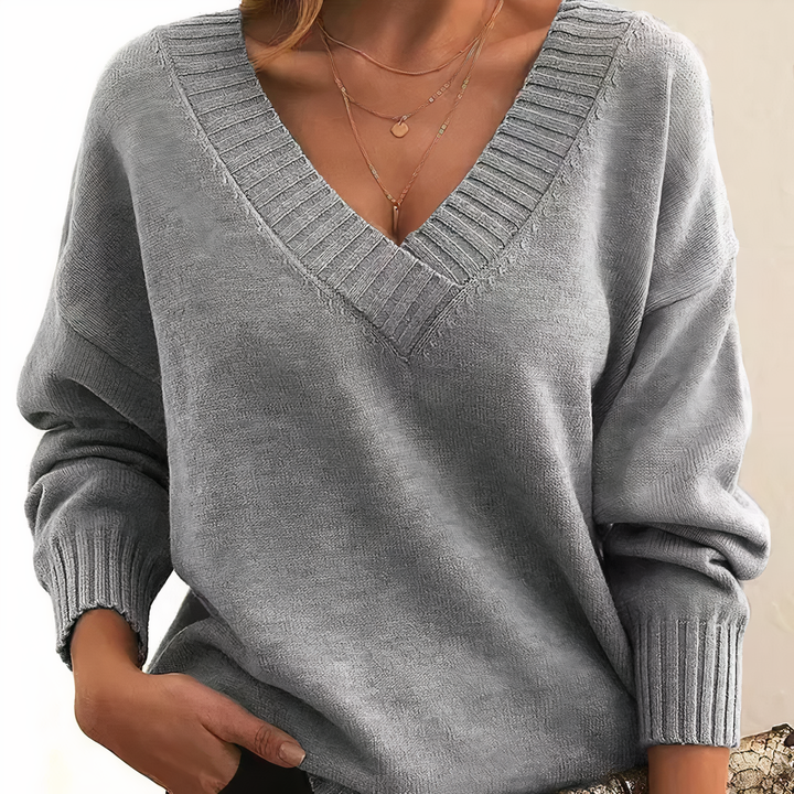 Gray sweater worn by a person on a neutral background