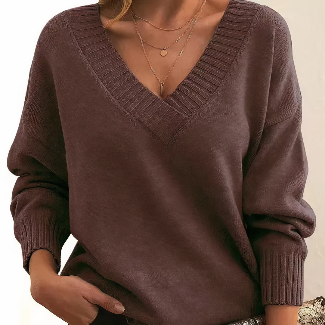 Brown sweater worn by a person on a beige background