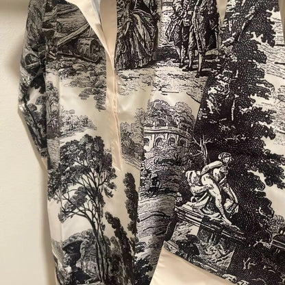 Black and white patterned fabric with classical design on a beige background