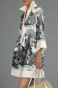 Person wearing a black and white patterned dress with a plain background