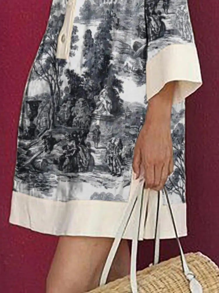 Person wearing a dress with a black and white landscape print against a red background